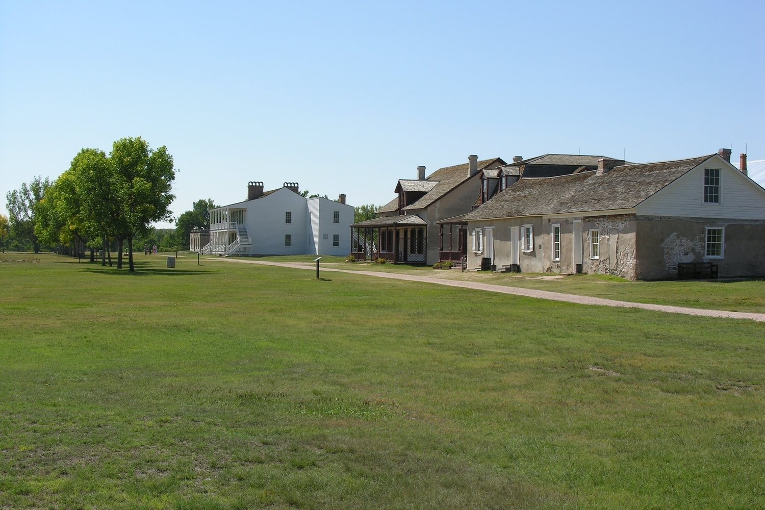 The whitewashed buildings of Fort Laramie under a wide plains sky.