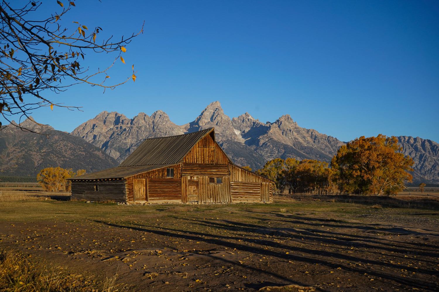 A weathered barn on Mormon Row with the Teton Range behind it.